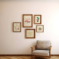 Framed artwork on a wall with a chair in front