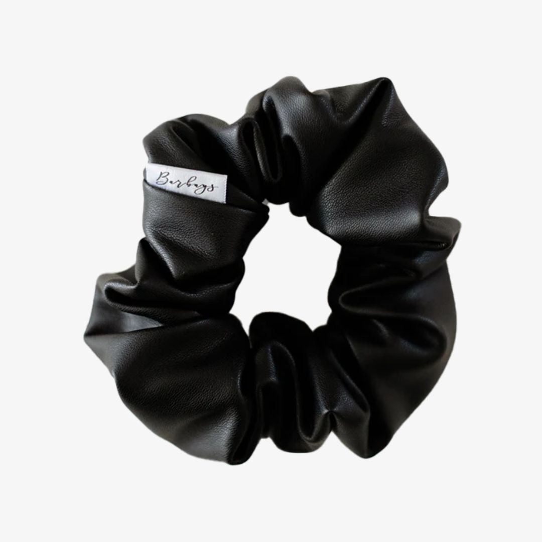 Black scrunchie with a brand label on a white background
