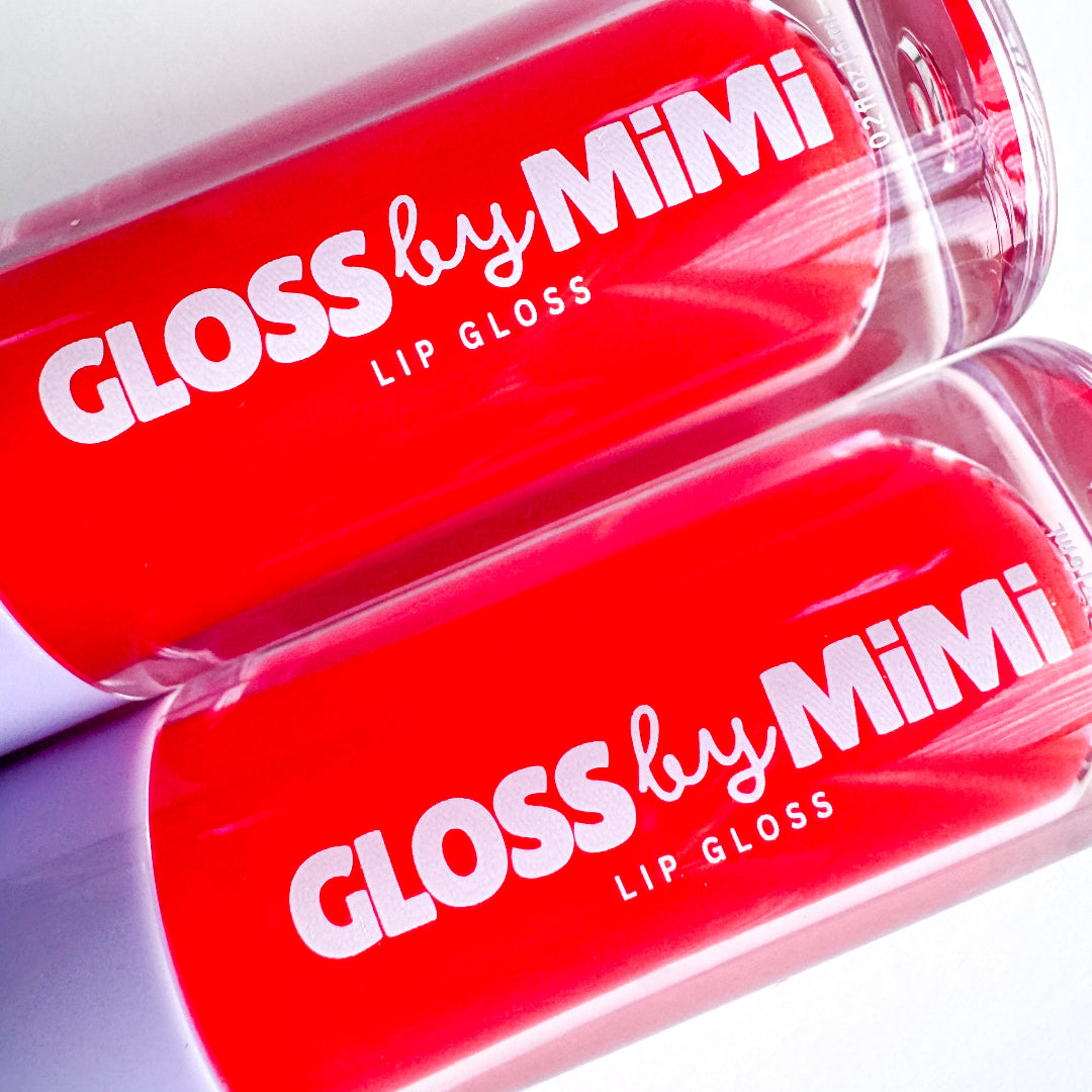 Two red lip glosses with 'Gloss by Mimi' branding on a white background