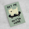 Embroidered patch with a dog on a skateboard and text 'GET ME OUTTA HERE' on a light green background.