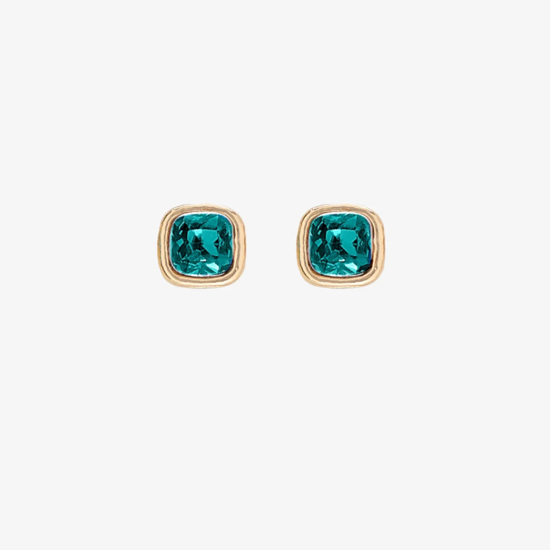 A set of three pairs of emerald earrings displayed on a green card. The set includes a pair of stud earrings, a pair of bar earrings with small emerald beads, and a pair of hoop earrings with dangling emerald stones. The card has the month "May" and the brand name "Foxy Originals."