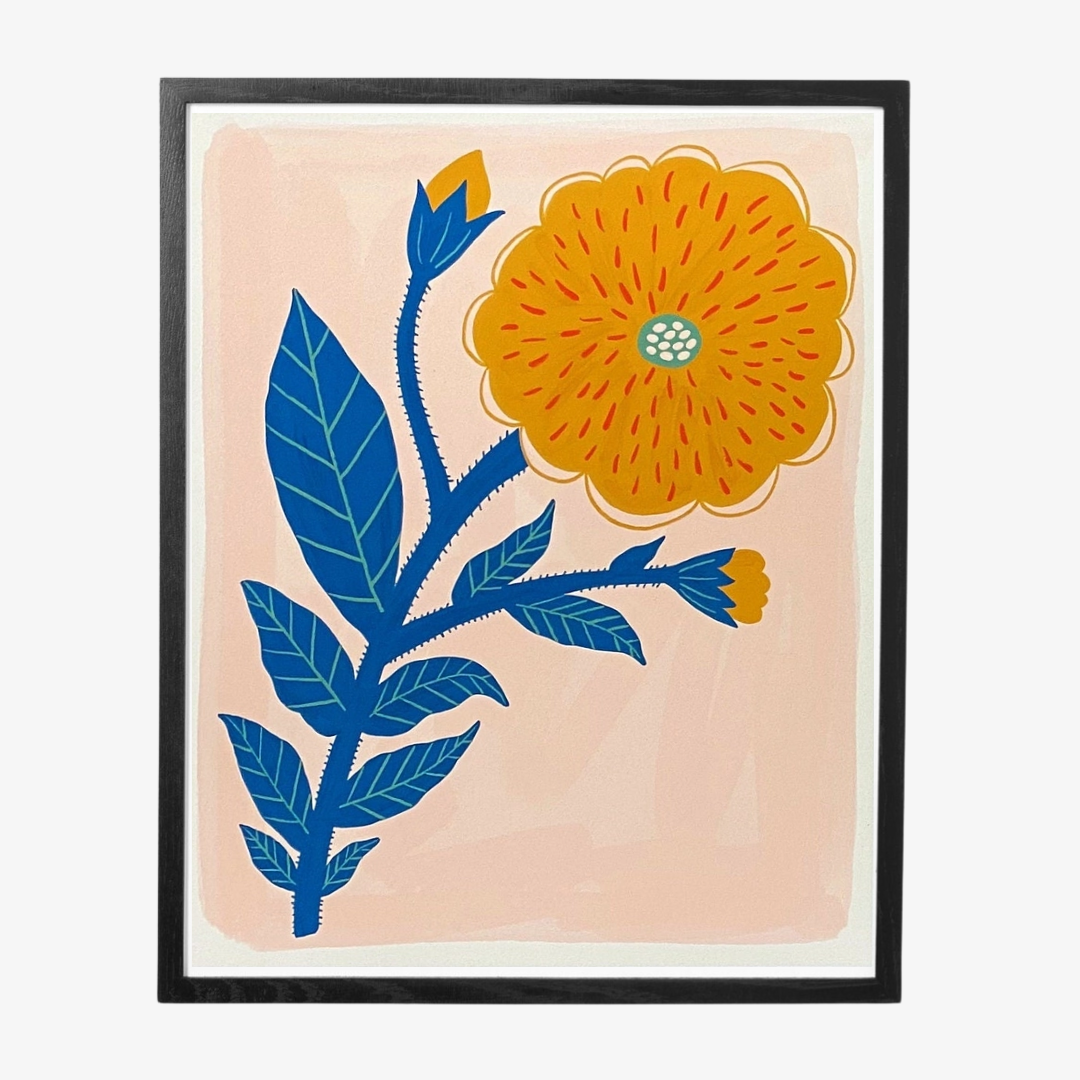 Yellow Flower Framed Art Print, a poster of a yellow flower on a peachy background in a black frame.