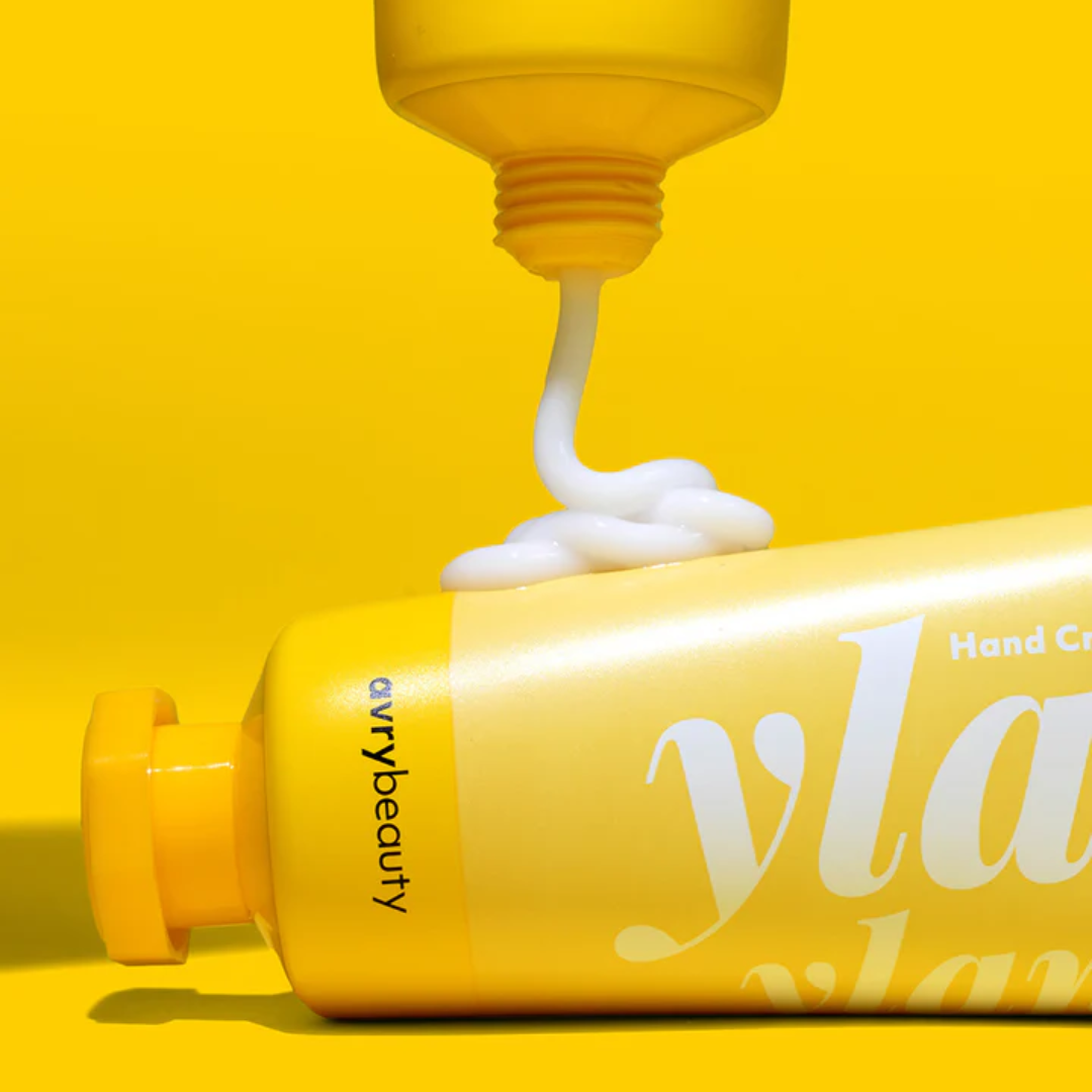 Two tubes of Ylang Ylang Shea Butter Lotion, one being squeezed out onto the other.