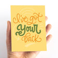 A card with a yellow background and the text "I've got your back" in green and orange lettering.