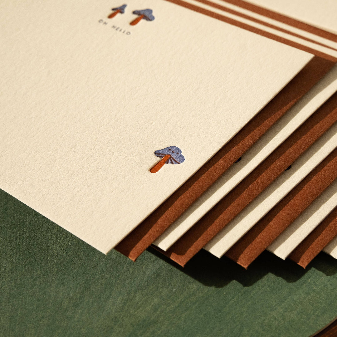 Set of stationery items with ice cream illustrations on a green surface