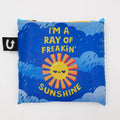 Pillow with sun design and text on a blue background
