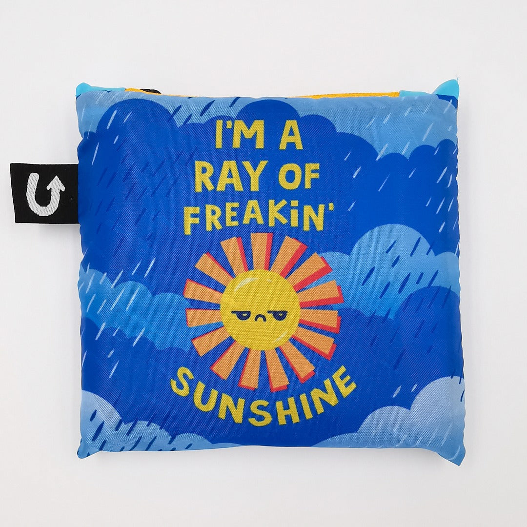 Pillow with sun design and text on a blue background