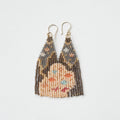 A pair of long, triangular tapestry-style earrings hand-stitched with small Japanese glass beads to depict a stylized face with light peach skin, blue eyes, coral cheeks, and a red mouth, framed by dark brown and grey hair with gold bead accents. They hang from delicate 14 KT gold filled fishhook ear wires.