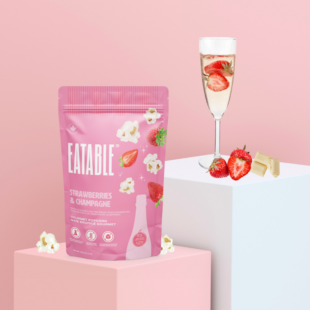 Eatable strawberries and champagne packaging with a glass of champagne and strawberries on a pink background