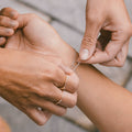 Close-up of hands with a focus on a bracelet and ring.