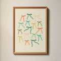 Colourful Bows Art Print in a wood frame hanging on a wall next to a window.
