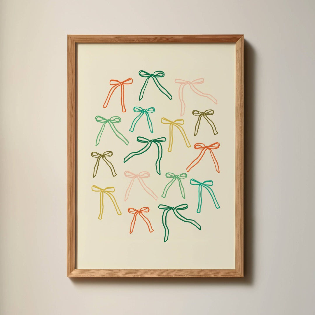 Colourful Bows Art Print in a wood frame hanging on a wall next to a window.