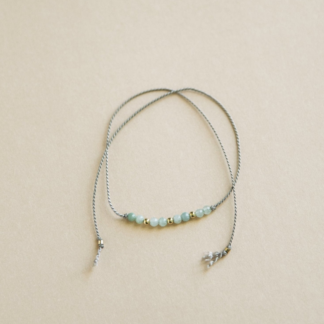 Bracelet with small beads on a beige background