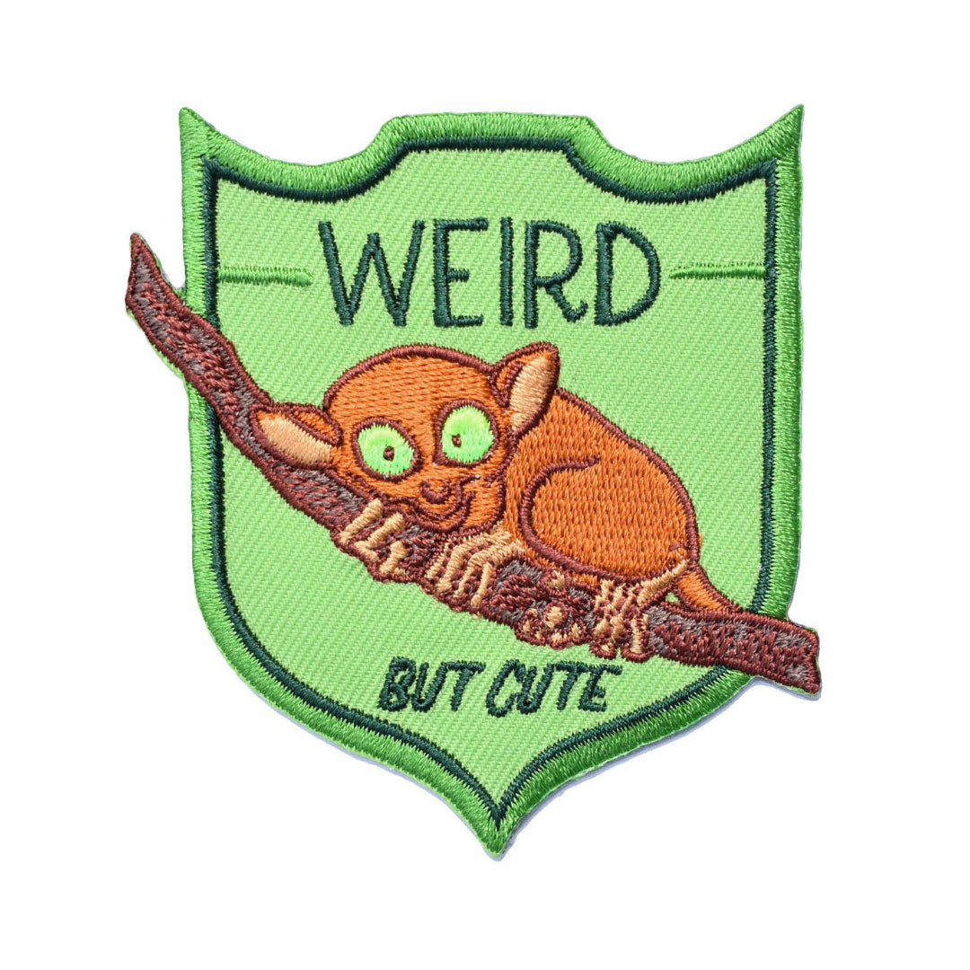 Patch with a small creature on a branch and text 'WEIRD BUT CUTE' on a green background